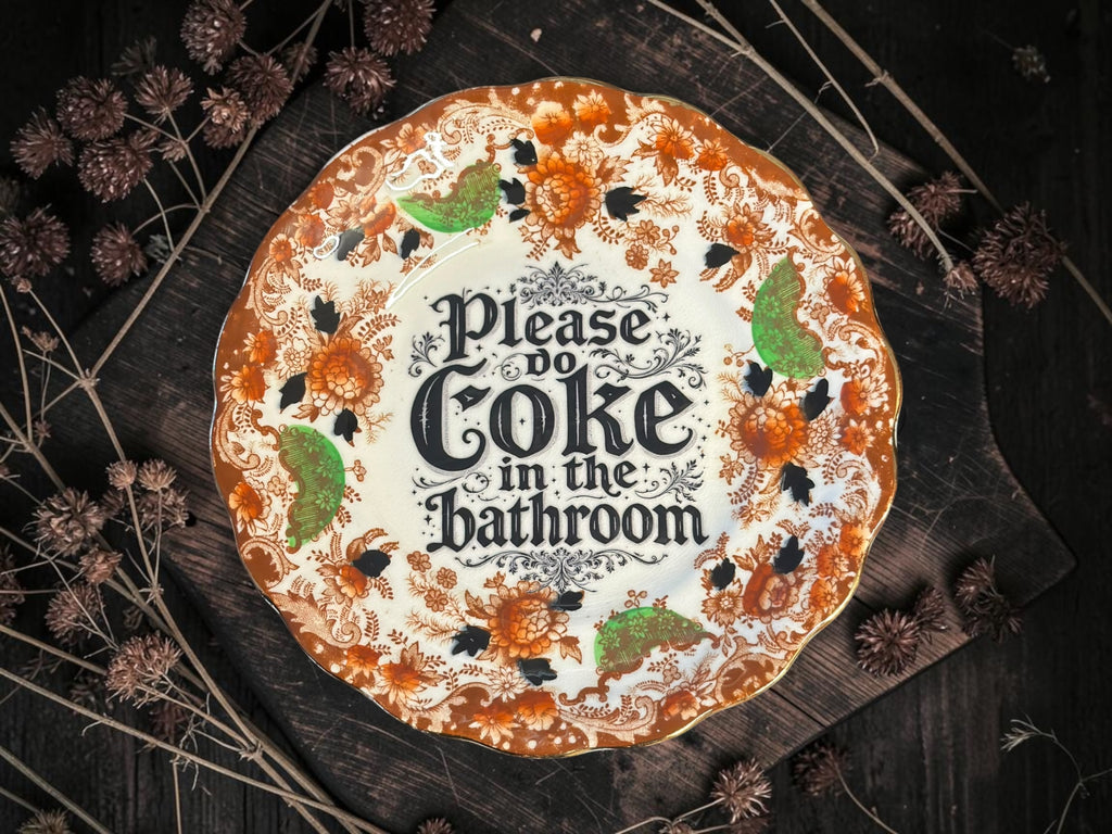 Vintage plate with the words Please Coke in the Bathroom