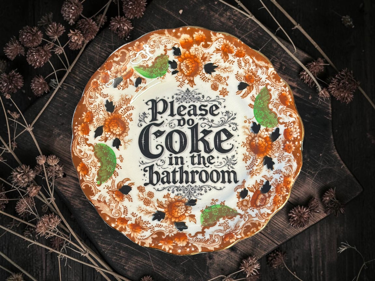 Vintage plate with the words Please Coke in the Bathroom