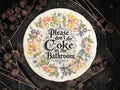 Vintage decorative plate reading Please Don’t Do Coke in the Bathroom