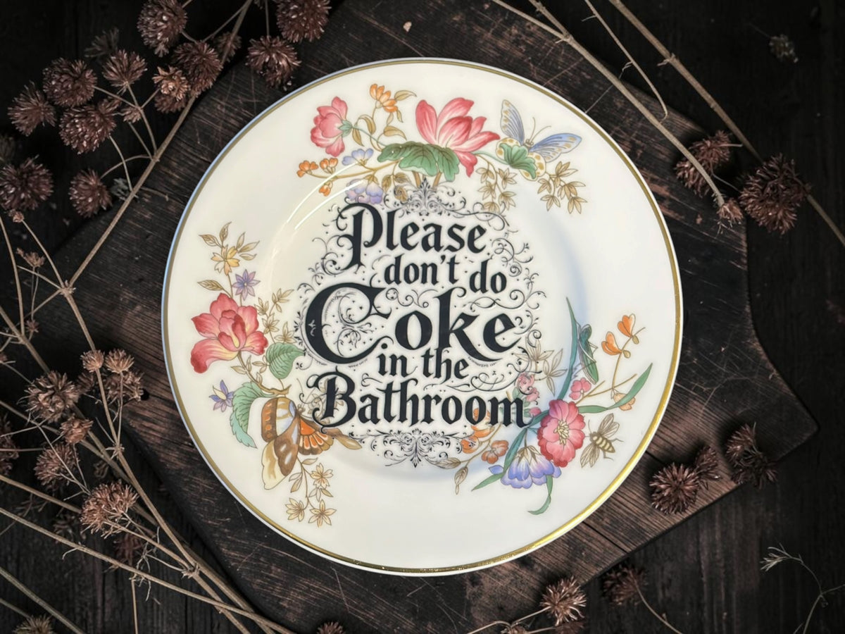 Vintage decorative plate reading Please Don’t Do Coke in the Bathroom