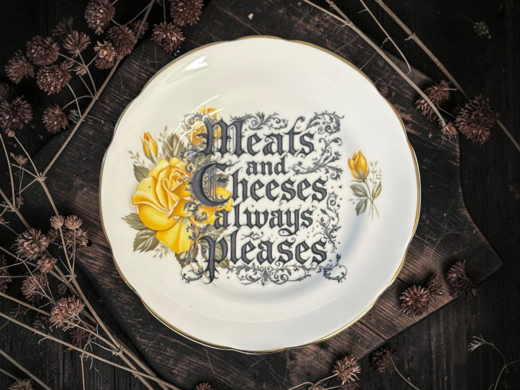 Vintage decorative plate reading Meats and Cheeses Always Please