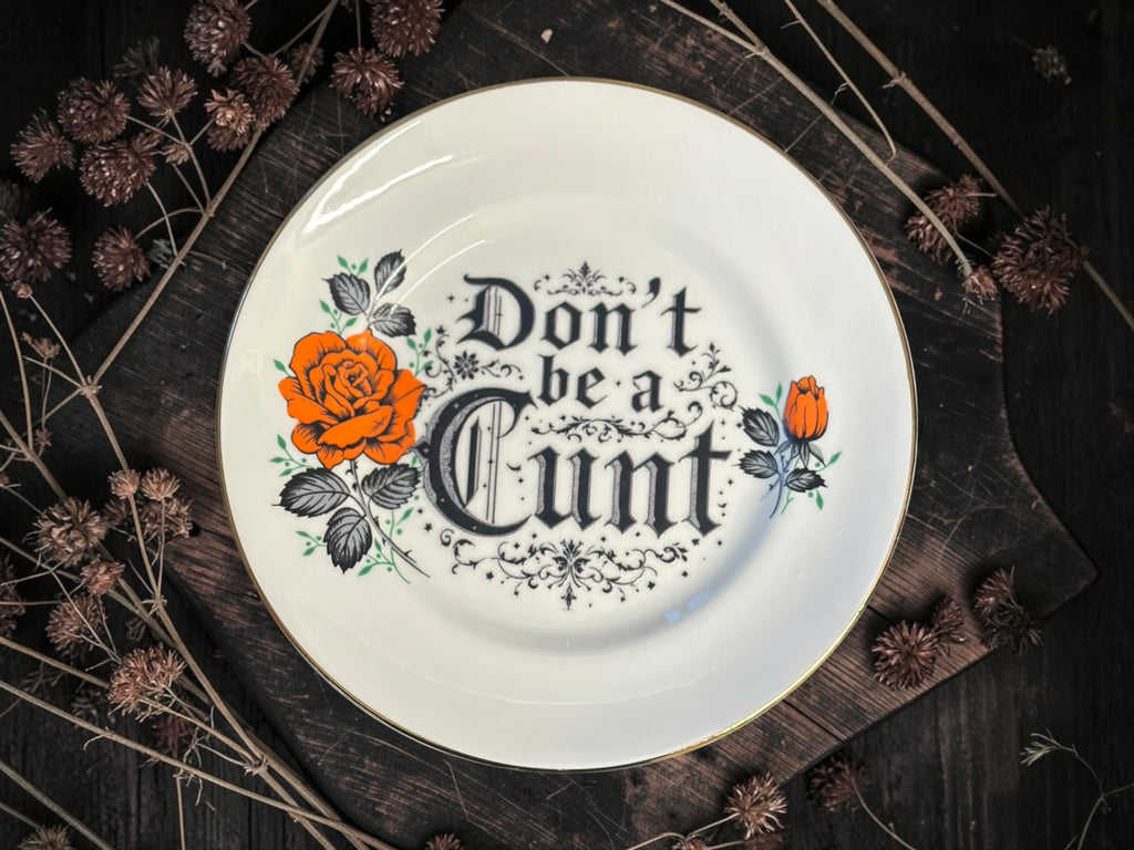 Vintage decorative plate reading Don't Be a Cunt