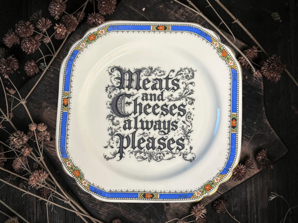 Vintage decorative plate reading Meats and Cheeses Always Please