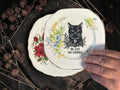 Vintage decorative plate reading Be Gay Do Crimes