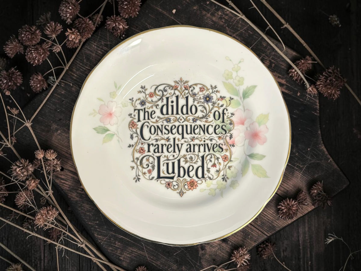 Vintage decorative plate featuring The Dildo of Consequences Rarely Arrives Lubed