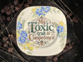 Vintage decorative plate featuring My Toxic Trait Is Competence