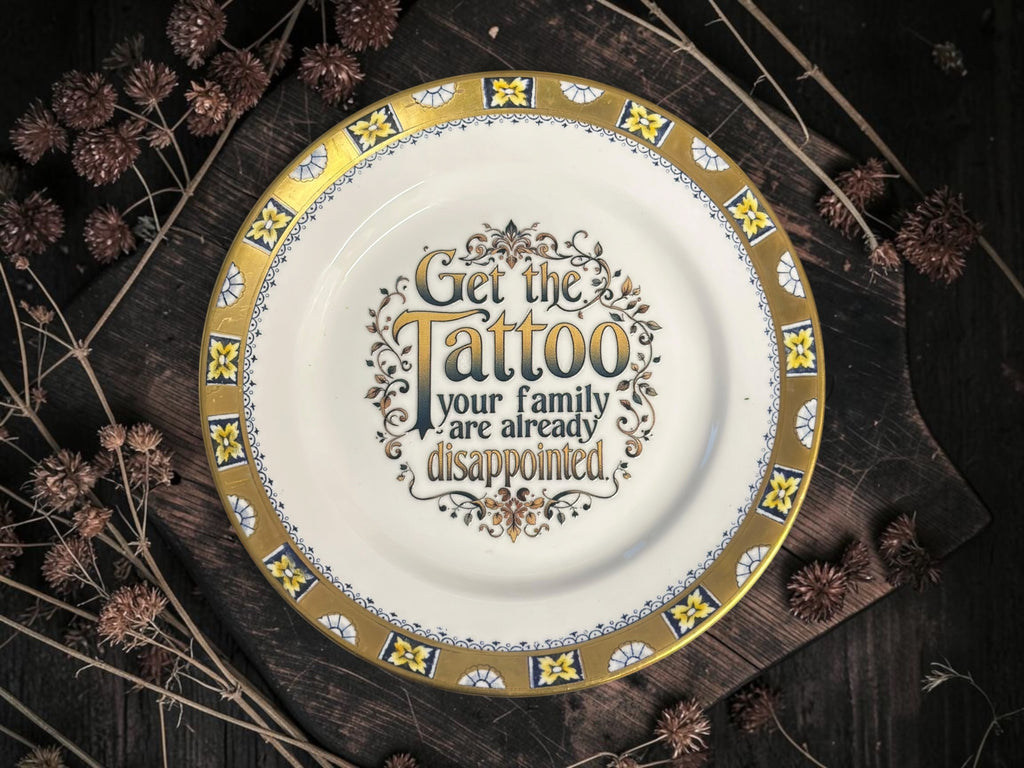 Vintage decorative plate reading Get the tattoo, your family are already disappointed