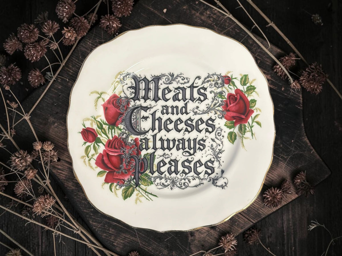 Vintage decorative plate reading Meats and cheeses always pleases