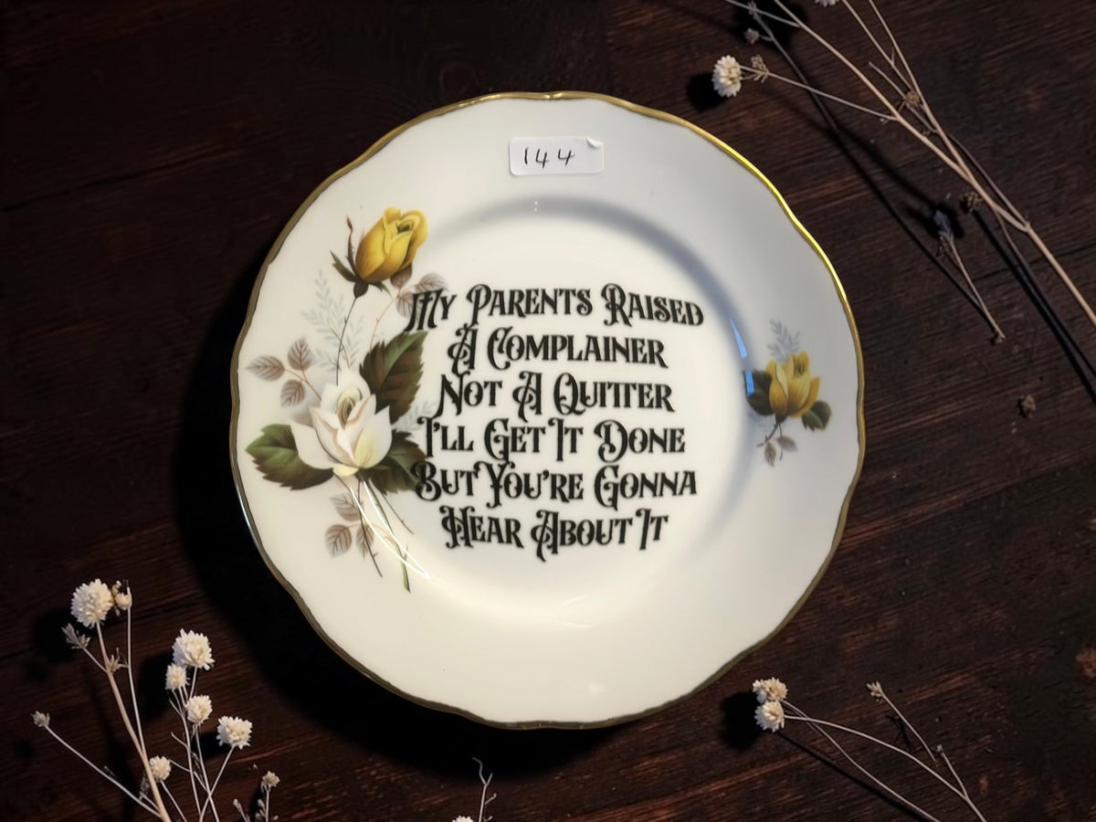 Yellow and white roses with gold rim vintage decorative plate reading My Parents Raised a Complainer, Not a Quitter. I'll Get It Done But You're Gonna Hear About It