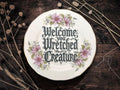 Welcome wretched creature, vintage plate with stand