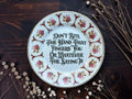 Vintage floral plate reading Don't Bite The Hand That Fingers You Or Whatever The Saying Is