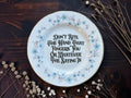 Blue floral vintage plate reading Don't Bite The Hand That Fingers You Or Whatever The Saying Is